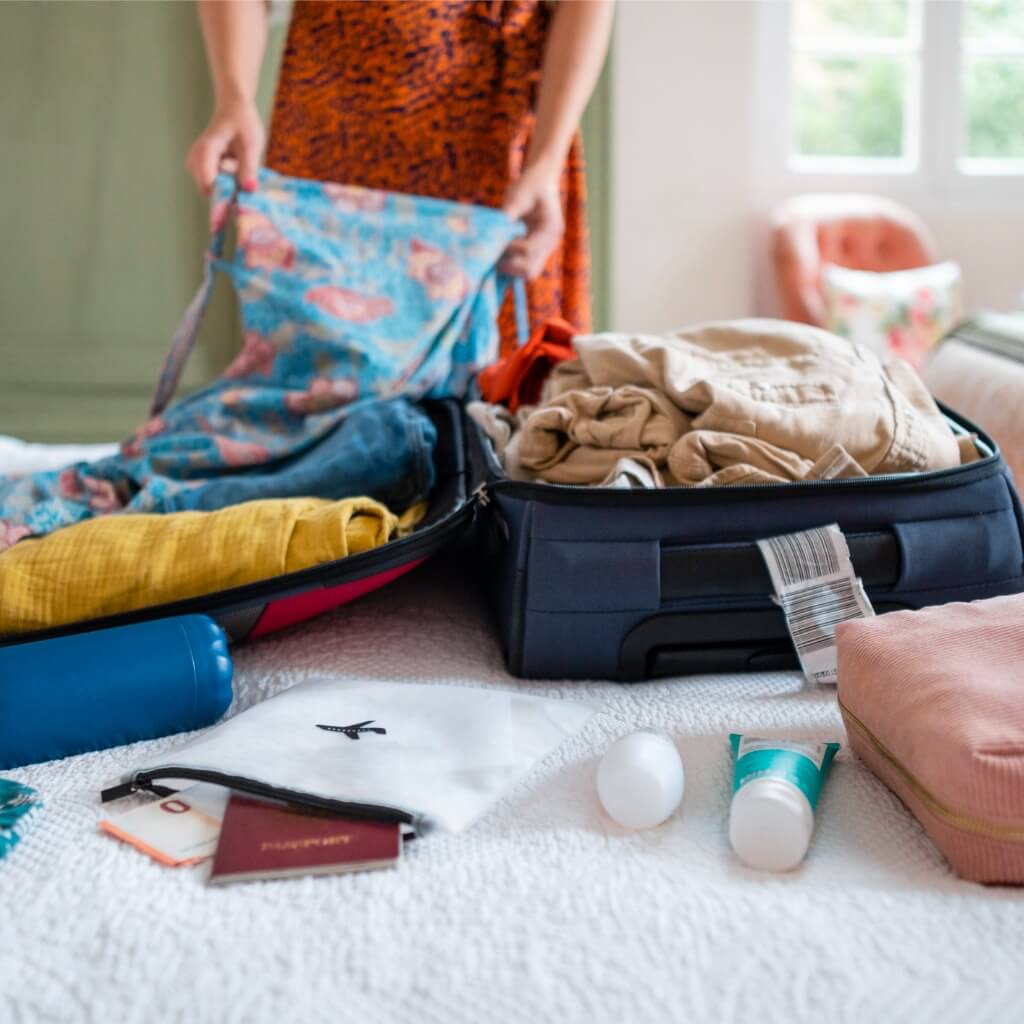 A travel nurse packing a suitcase.
