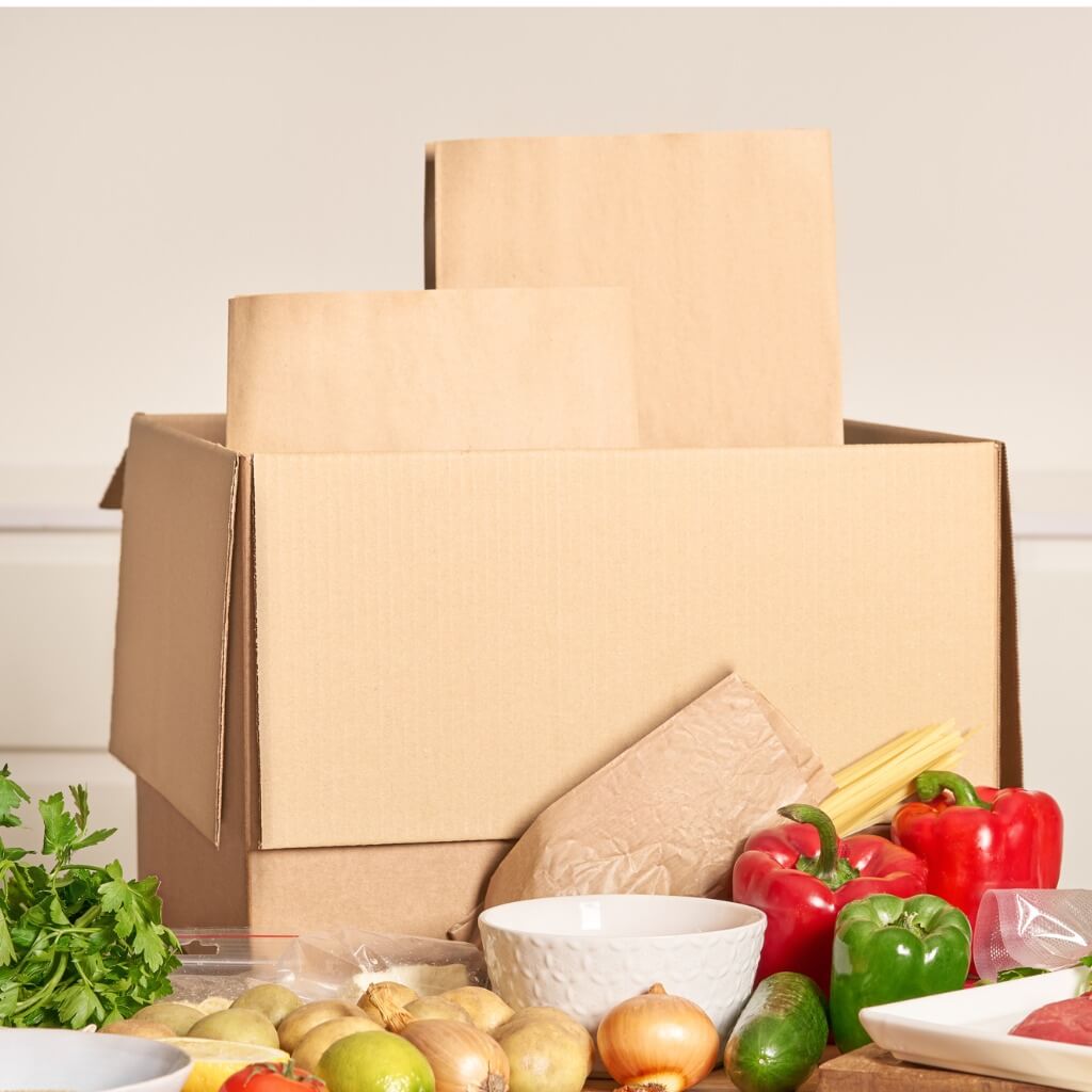 Picture of a box and meal ingredients suggesting a meal kit delivery service.