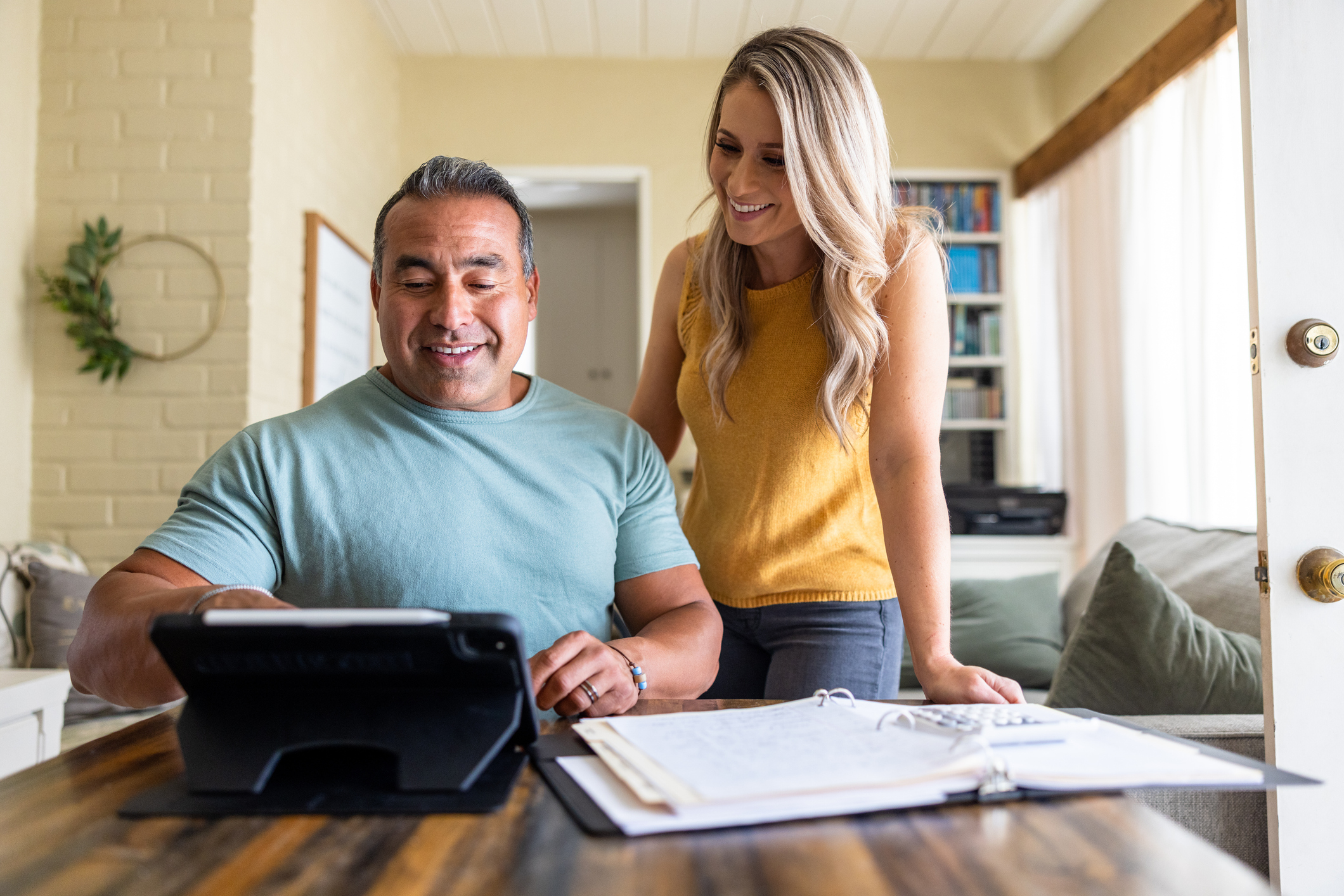 Diverse married couple at home working on their home finances